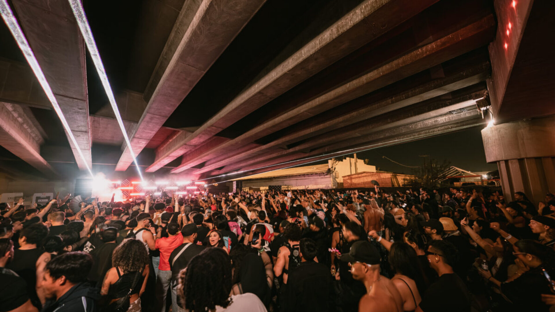 Arizona desert rave with colored lights and crowd dancing at night