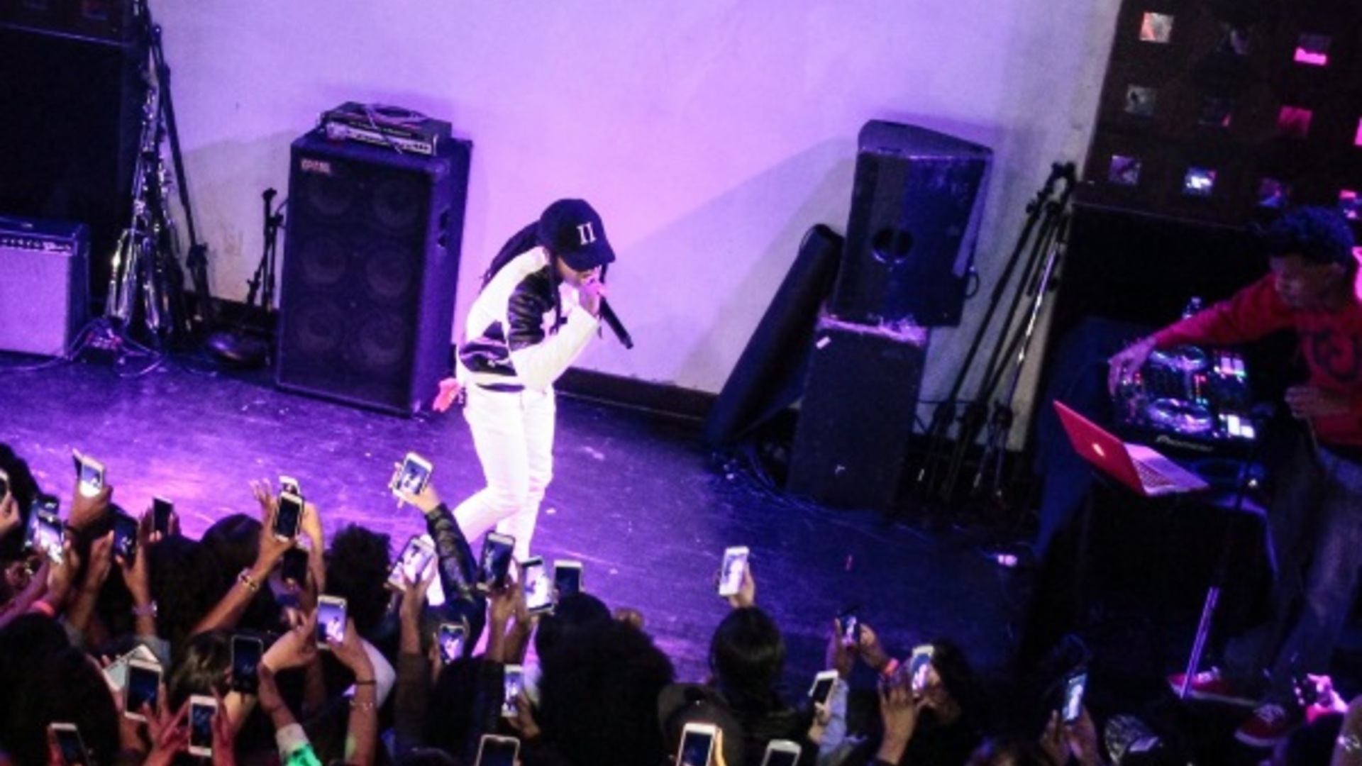 Rapper performing in intimate packed club close to the crowd